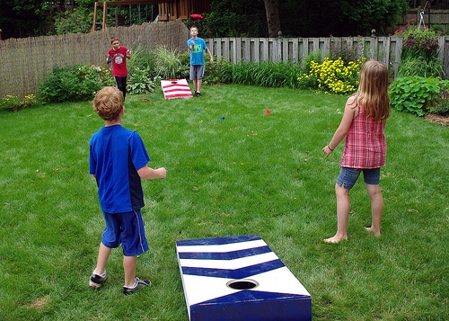 Kids playing cornhole