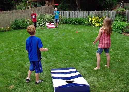 Kids playing cornhole