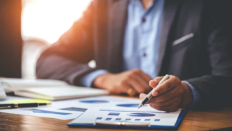 Businessman analyzing financial charts for retirement planning
